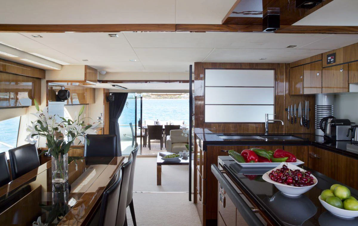 a kitchen with a table and chairs aboard D5 Yacht for Charter
