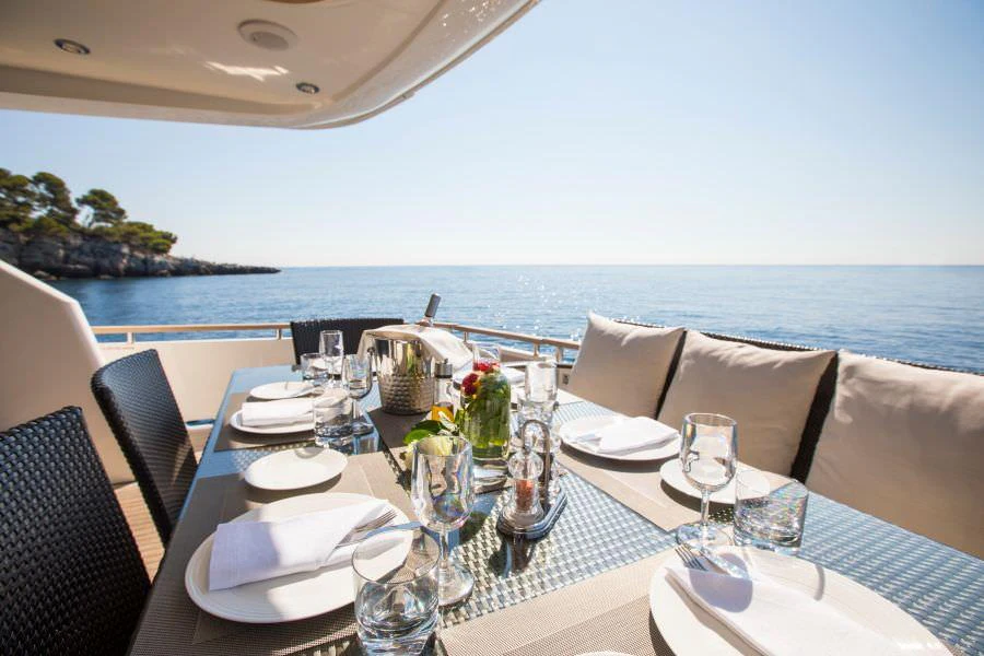 a table set for a dinner aboard D5 Yacht for Charter