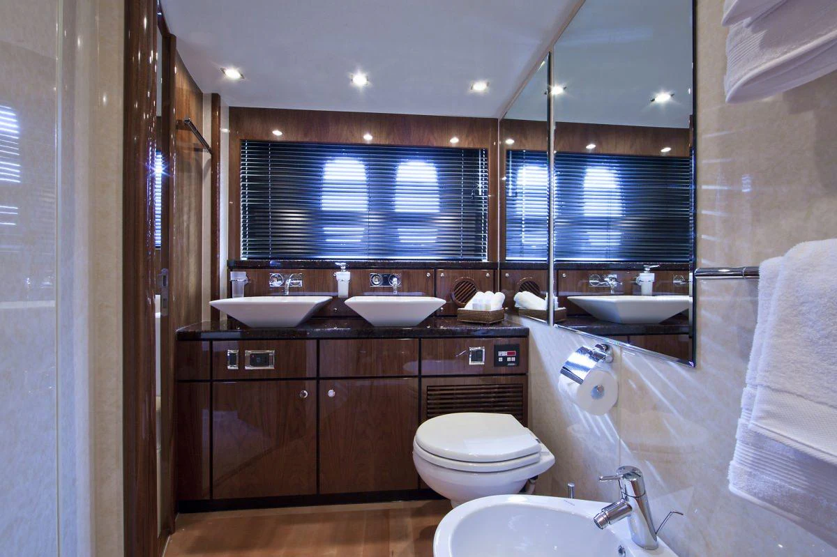a bathroom with a tub sink and toilet aboard D5 Yacht for Charter