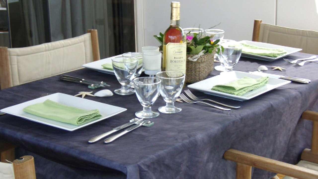 a table with plates and wine bottles aboard SORANA Yacht for Charter