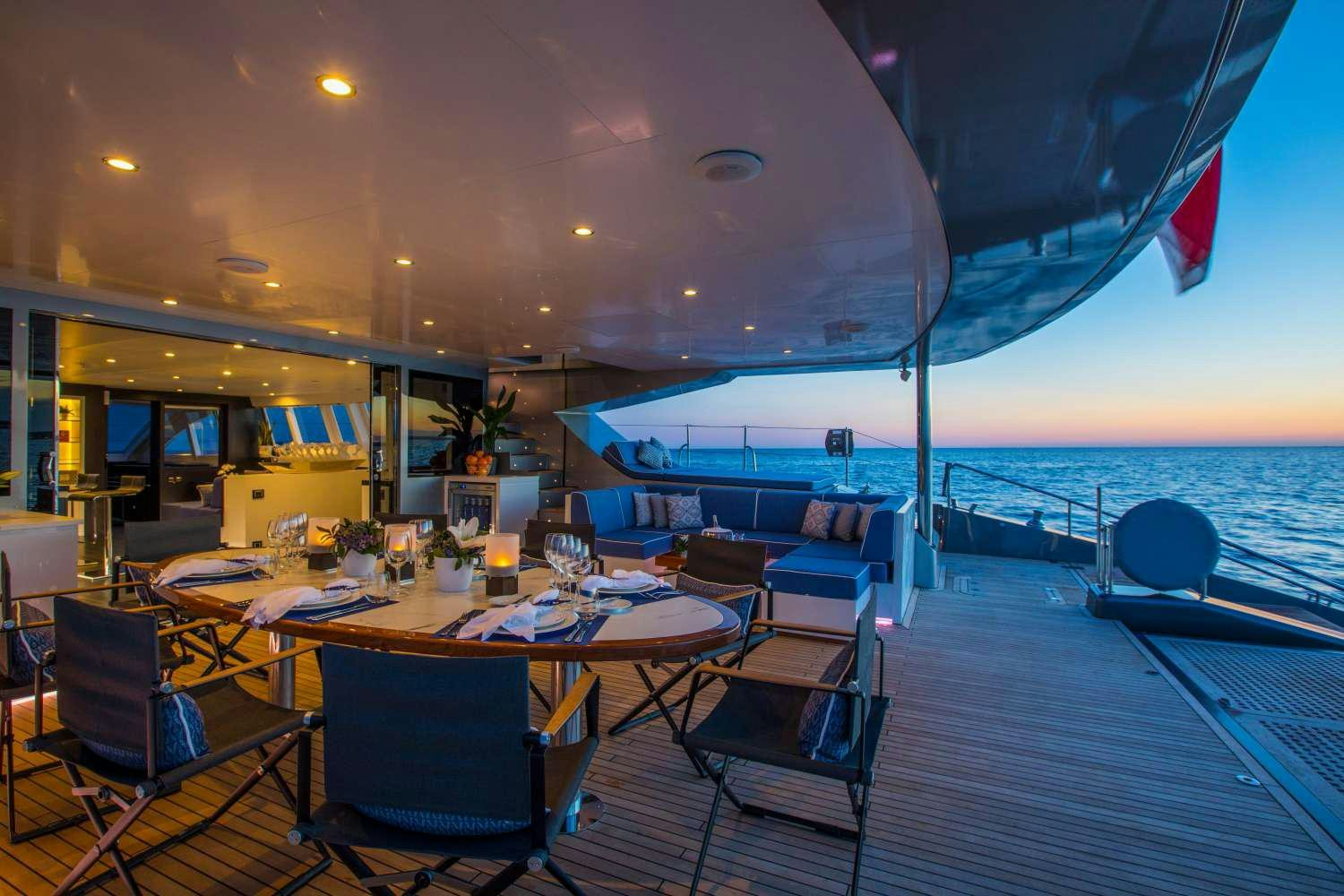 a room with a table and chairs aboard CARTOUCHE Yacht for Charter