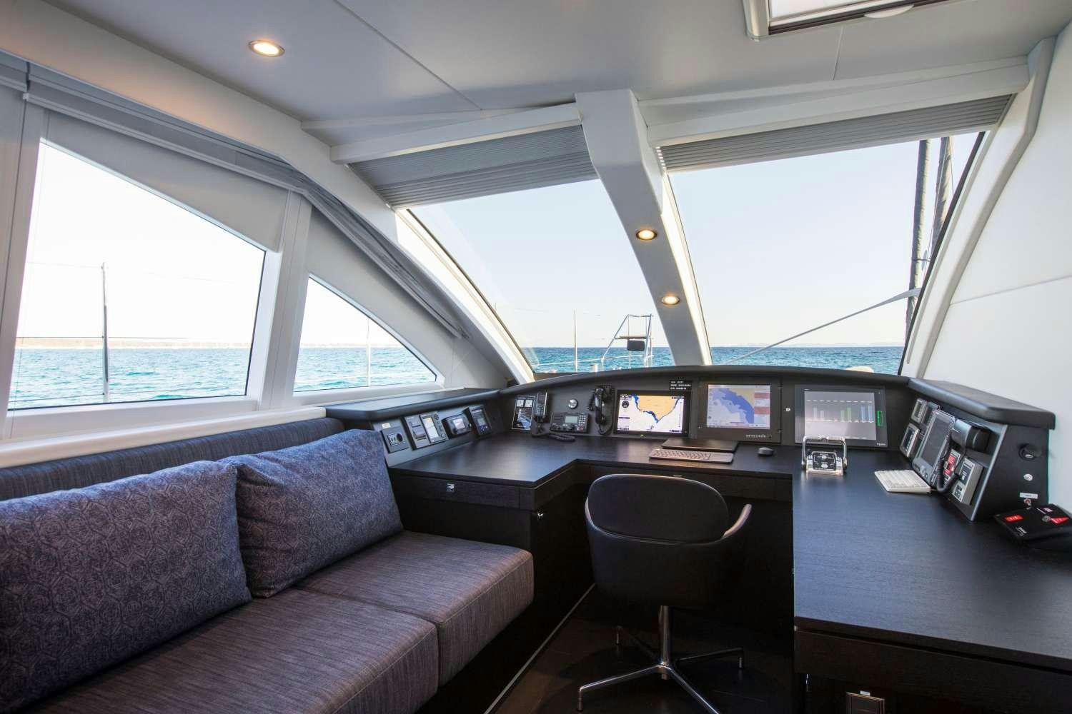 a vehicle with a couch and a chair in it aboard CARTOUCHE Yacht for Charter