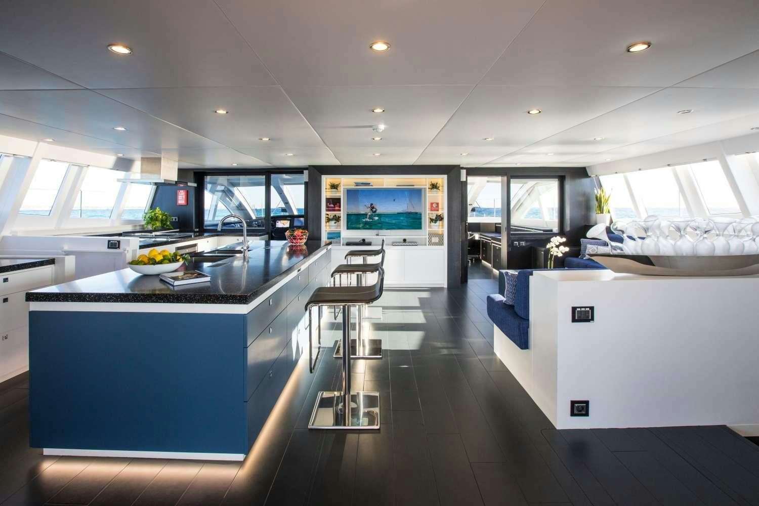 a kitchen with a large island aboard CARTOUCHE Yacht for Charter