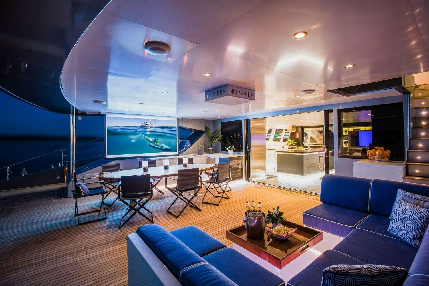 a living room with a large glass wall aboard CARTOUCHE Yacht for Charter