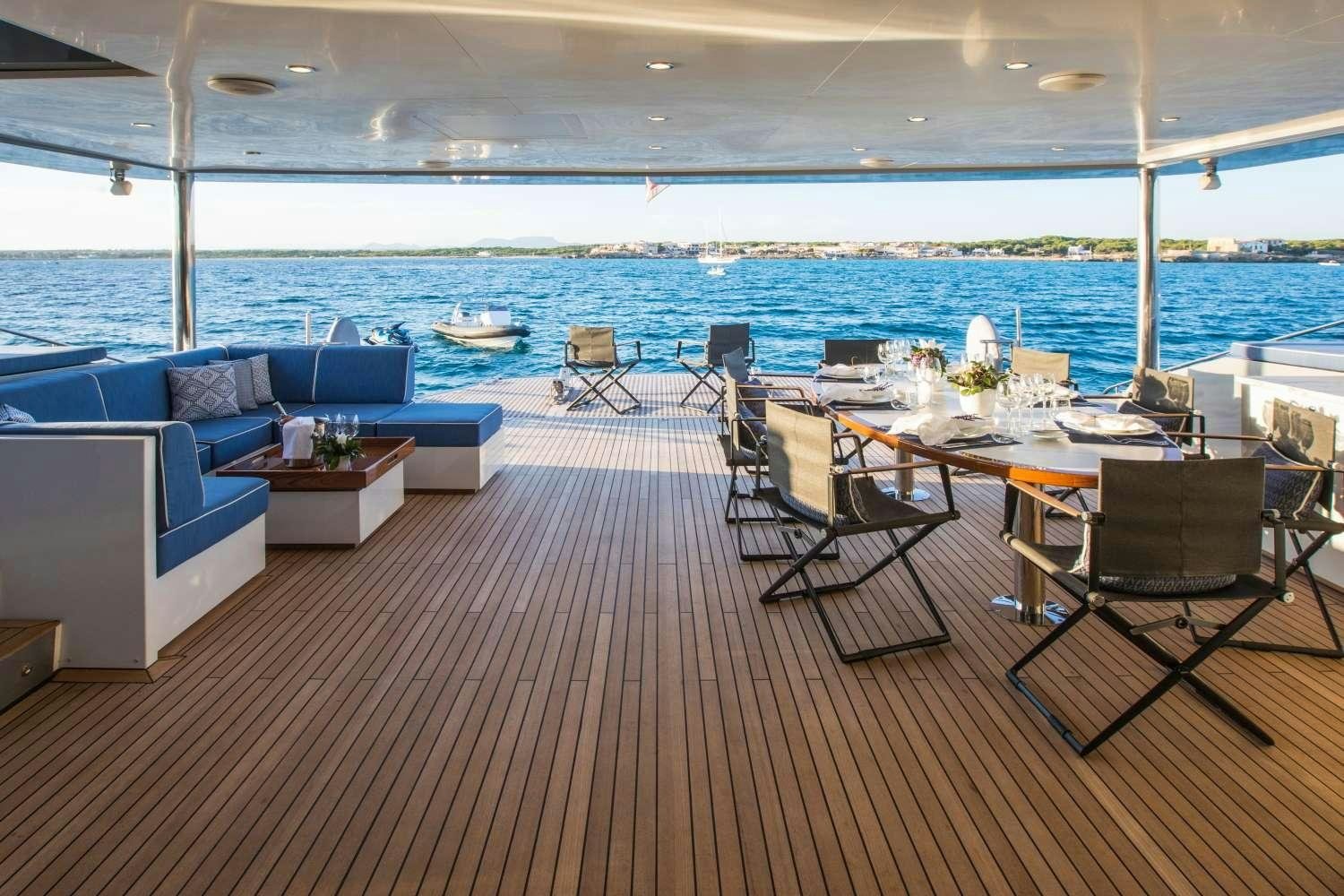 a room with a table and chairs aboard CARTOUCHE Yacht for Charter