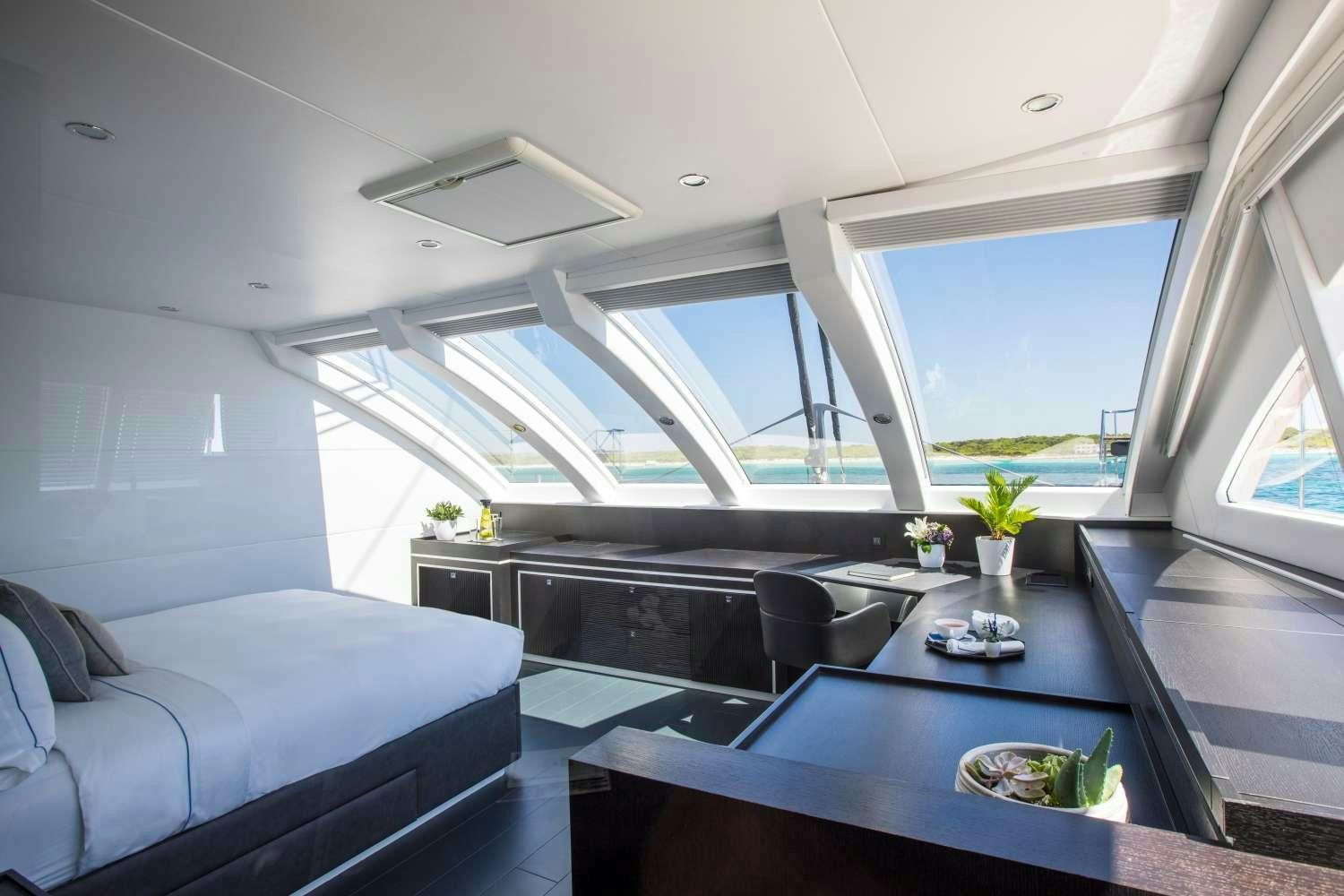 a room with a couch and a table aboard CARTOUCHE Yacht for Charter