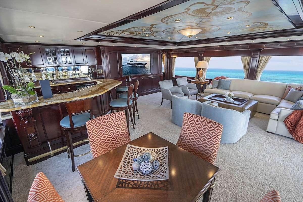 a room with a table chairs and a large window aboard MISS CHRISTINE Yacht for Charter