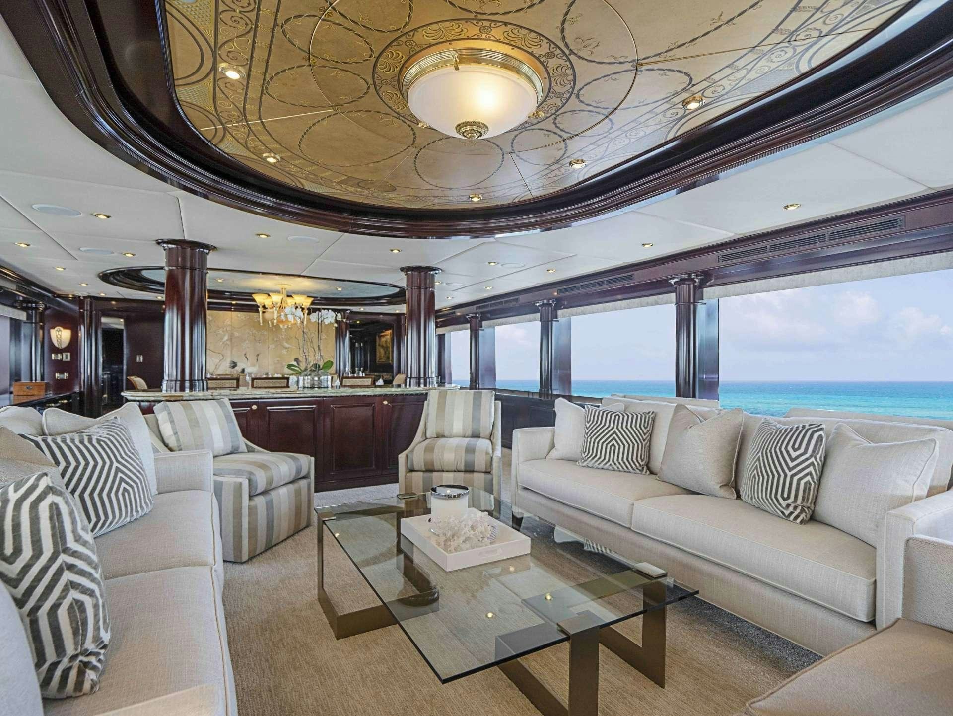 a large living room with a chandelier aboard MISS CHRISTINE Yacht for Charter