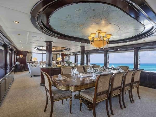 a large dining room with a chandelier aboard MISS CHRISTINE Yacht for Charter