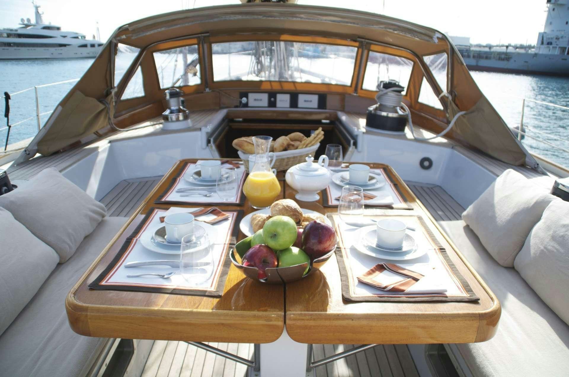 a table with food and drinks on it aboard VOLADOR Yacht for Charter