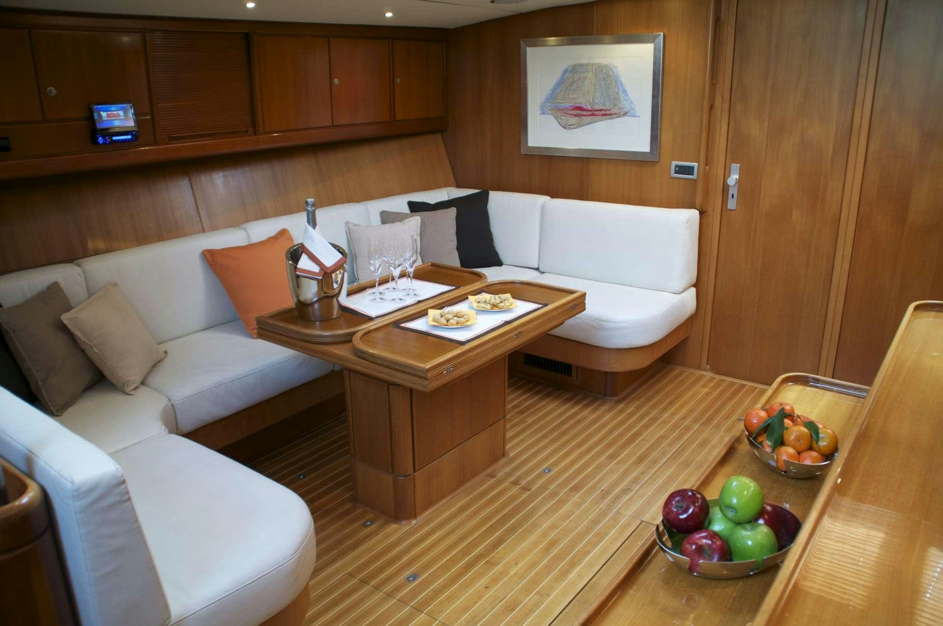a living room with a couch and a table aboard VOLADOR Yacht for Charter