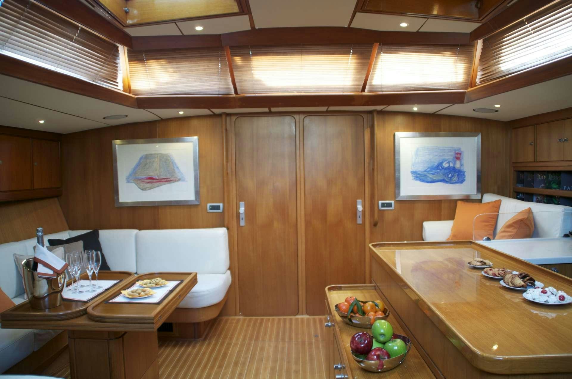 a room with a table and chairs aboard VOLADOR Yacht for Charter
