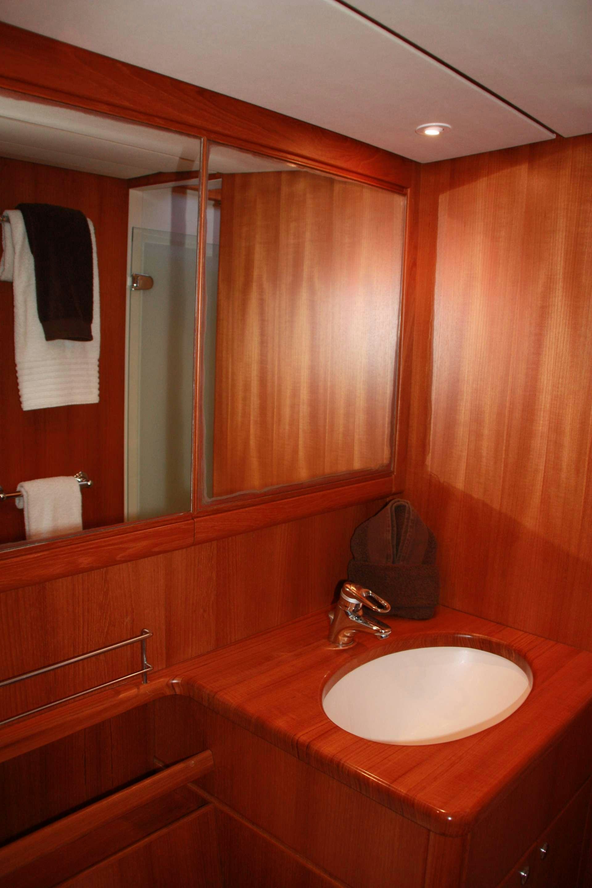 a bathroom with a sink and a mirror aboard VOLADOR Yacht for Charter