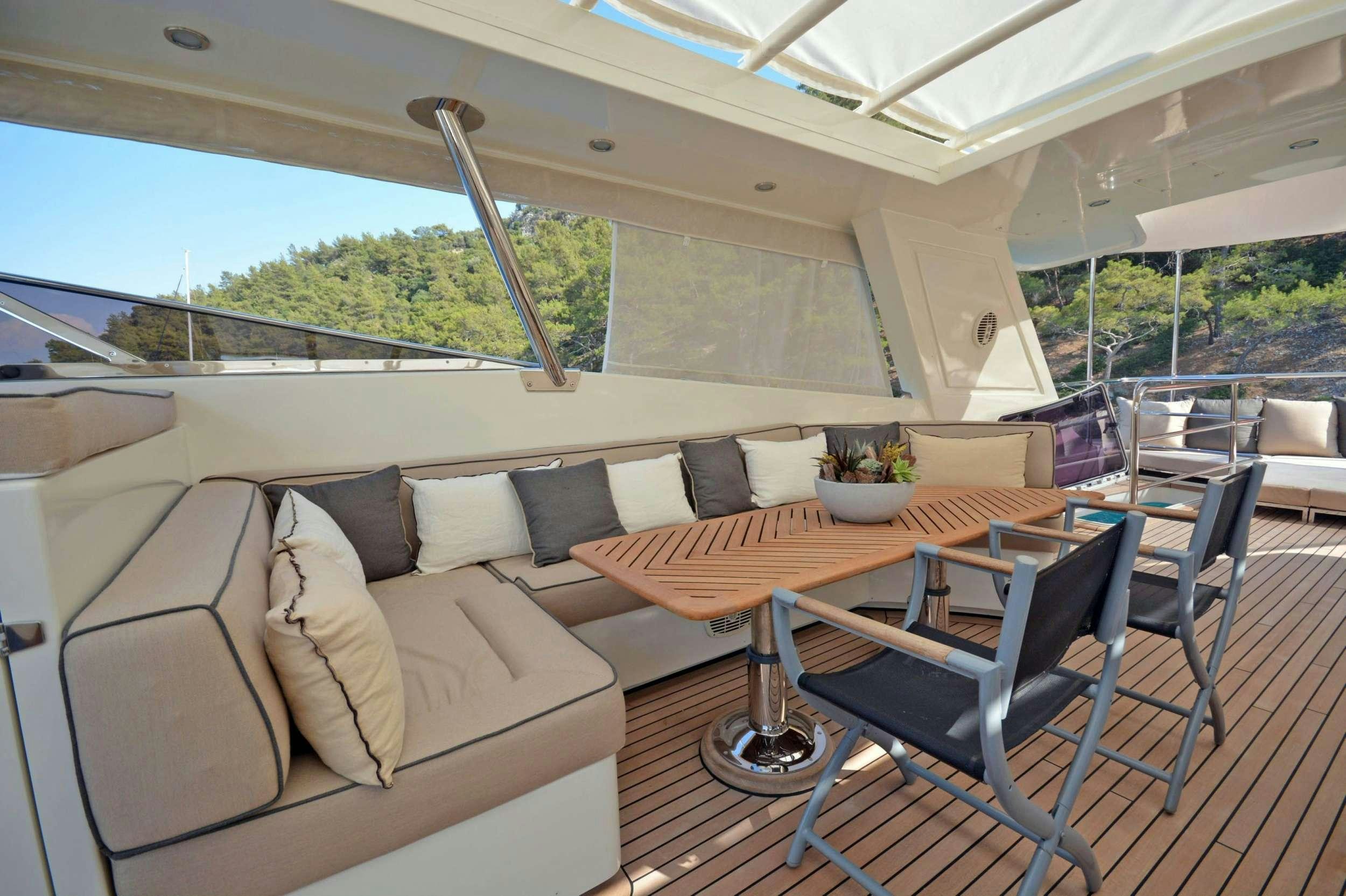 a living room with a couch and a table aboard GO Yacht for Charter