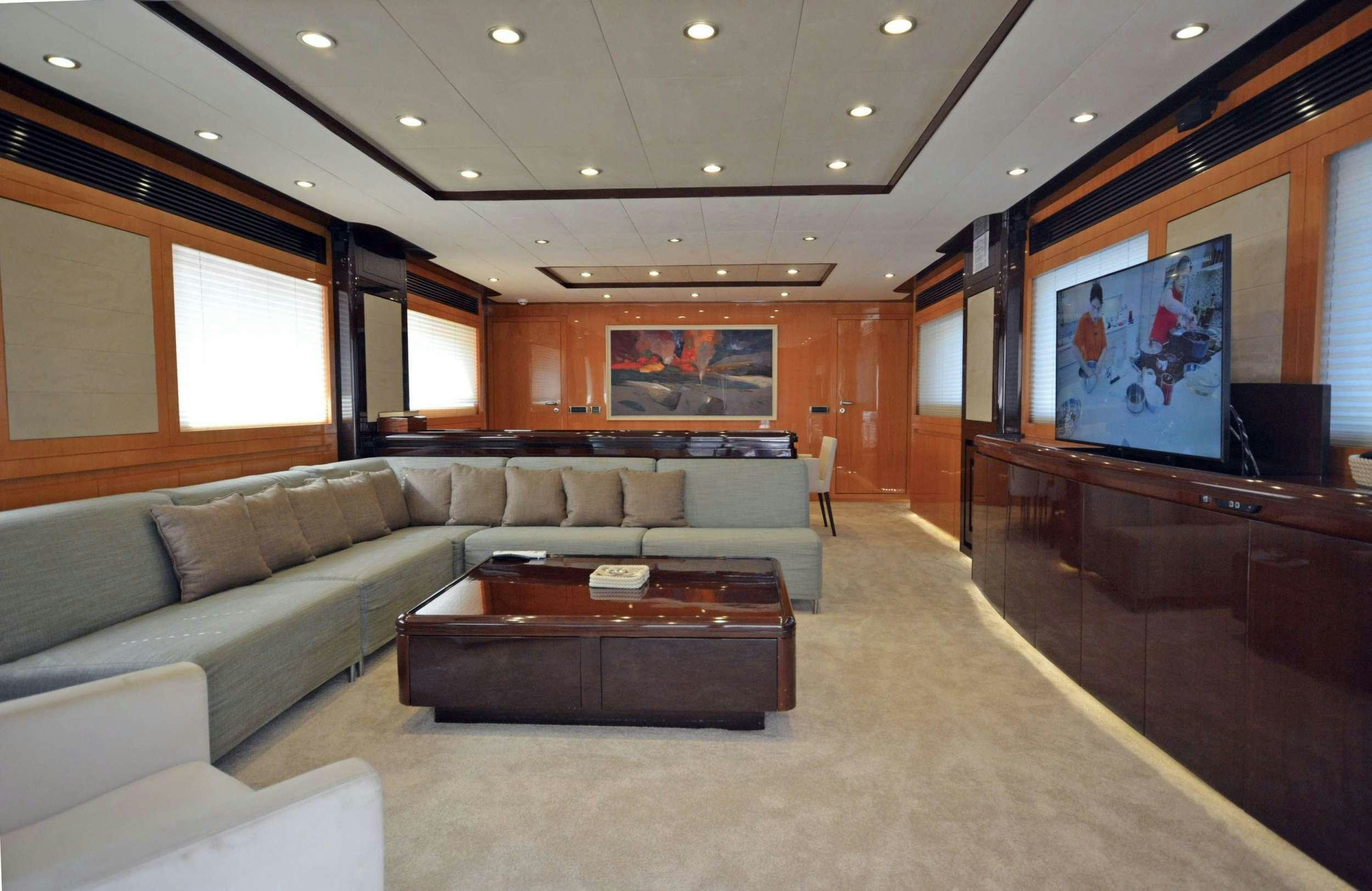 a living room with a large screen aboard GO Yacht for Charter
