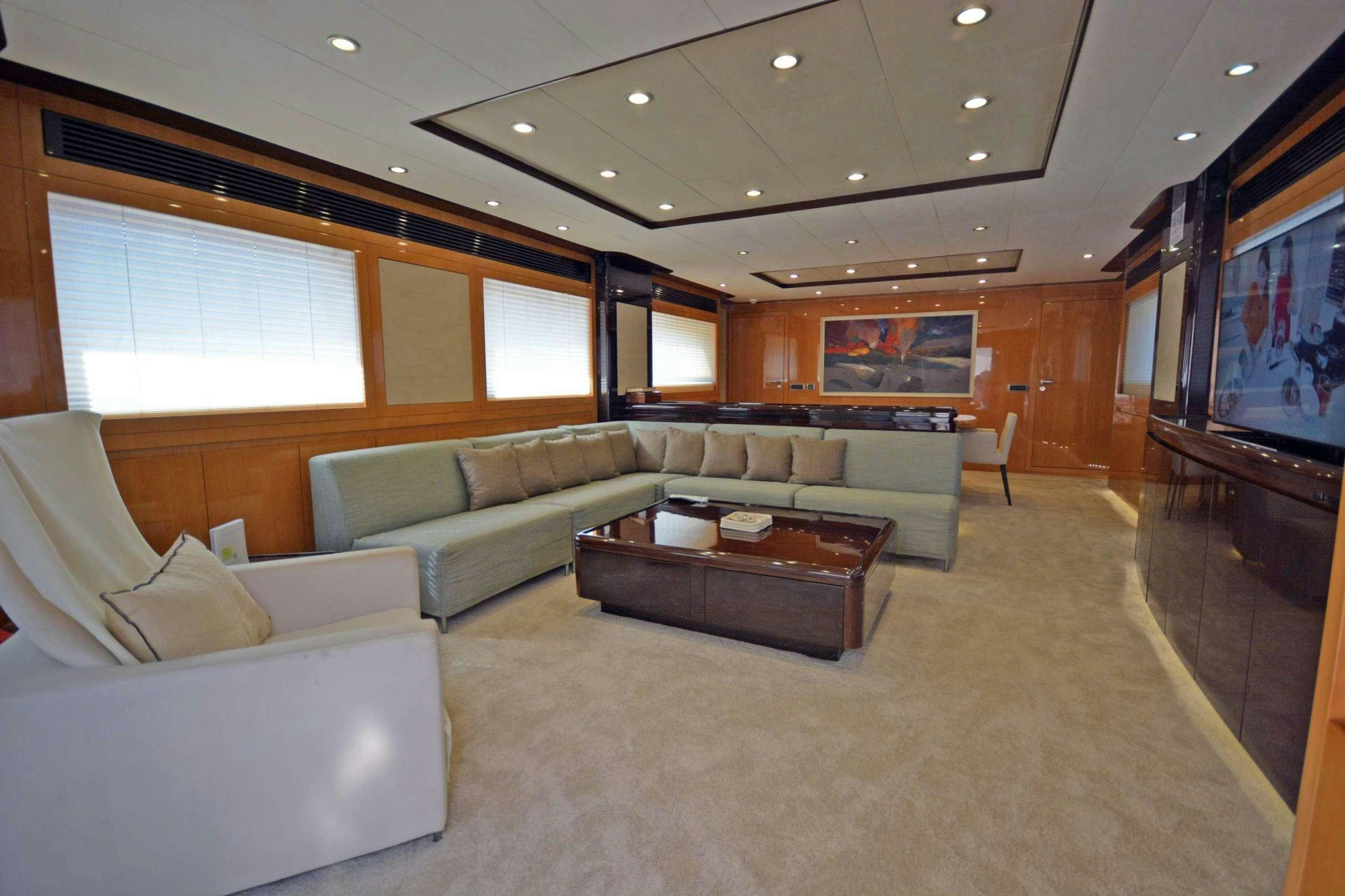 a living room with a large screen aboard GO Yacht for Charter