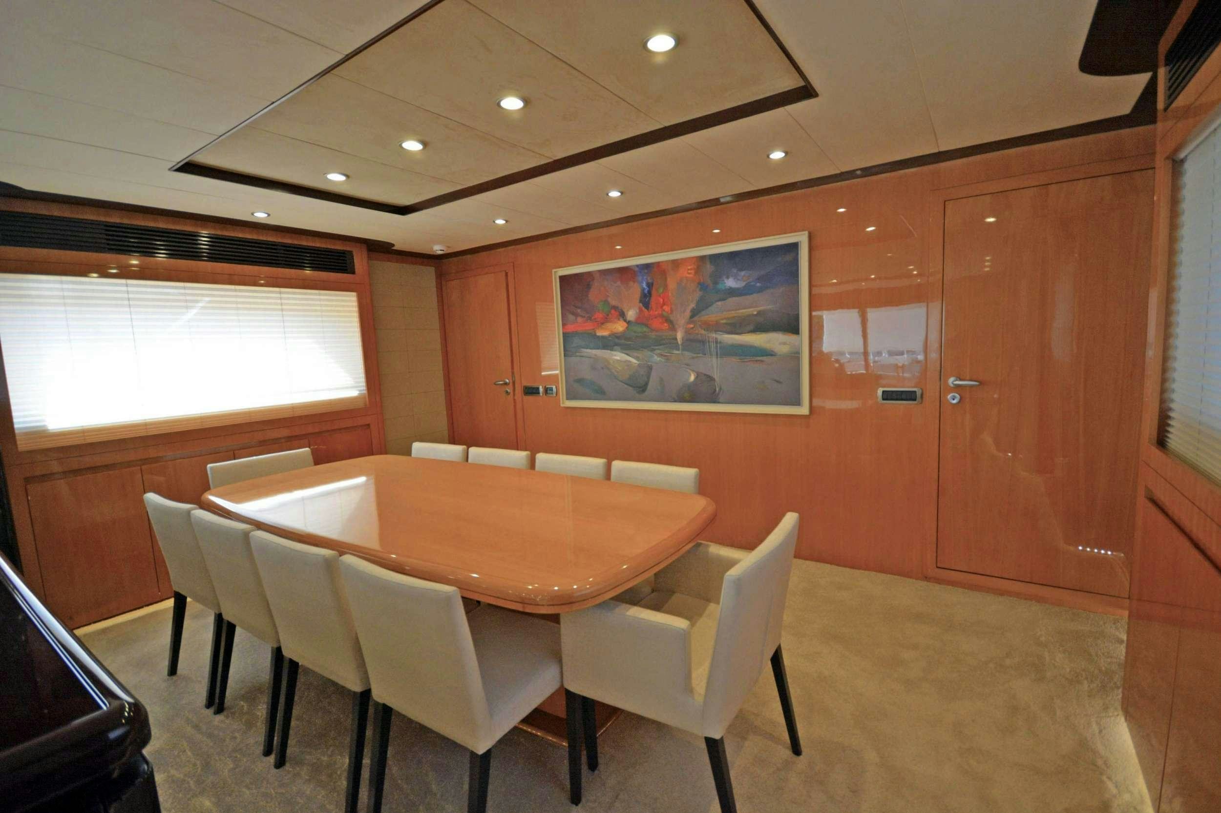 a conference room with tables and chairs aboard GO Yacht for Charter