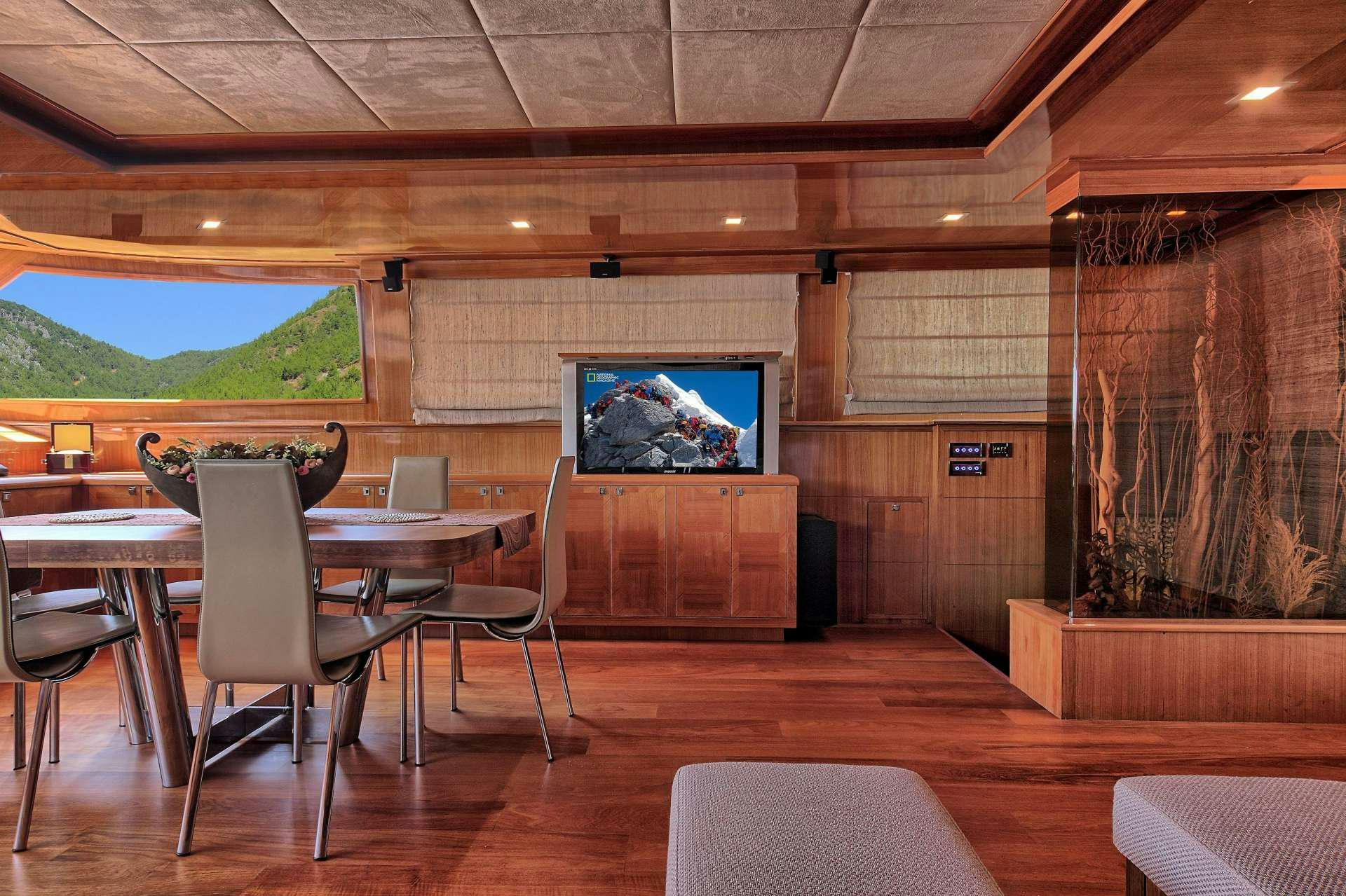 a room with a table and chairs aboard GO Yacht for Charter