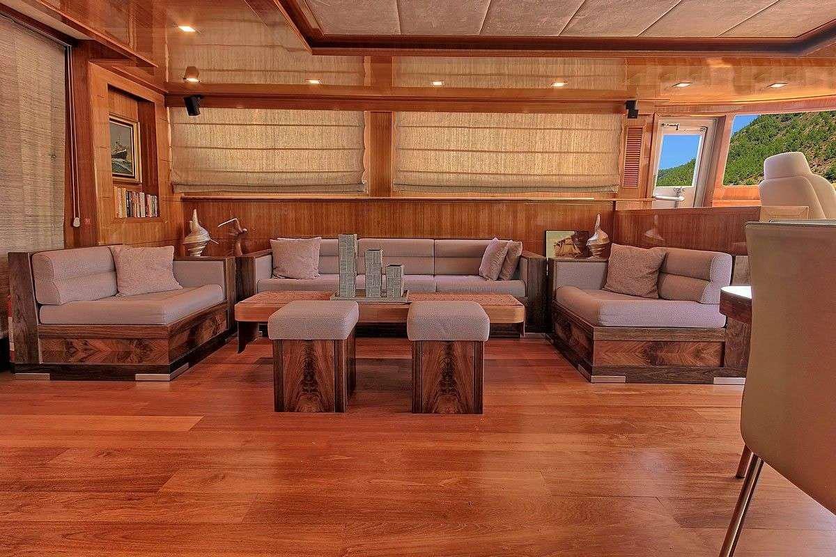 a living room with a couch and a table aboard GO Yacht for Charter