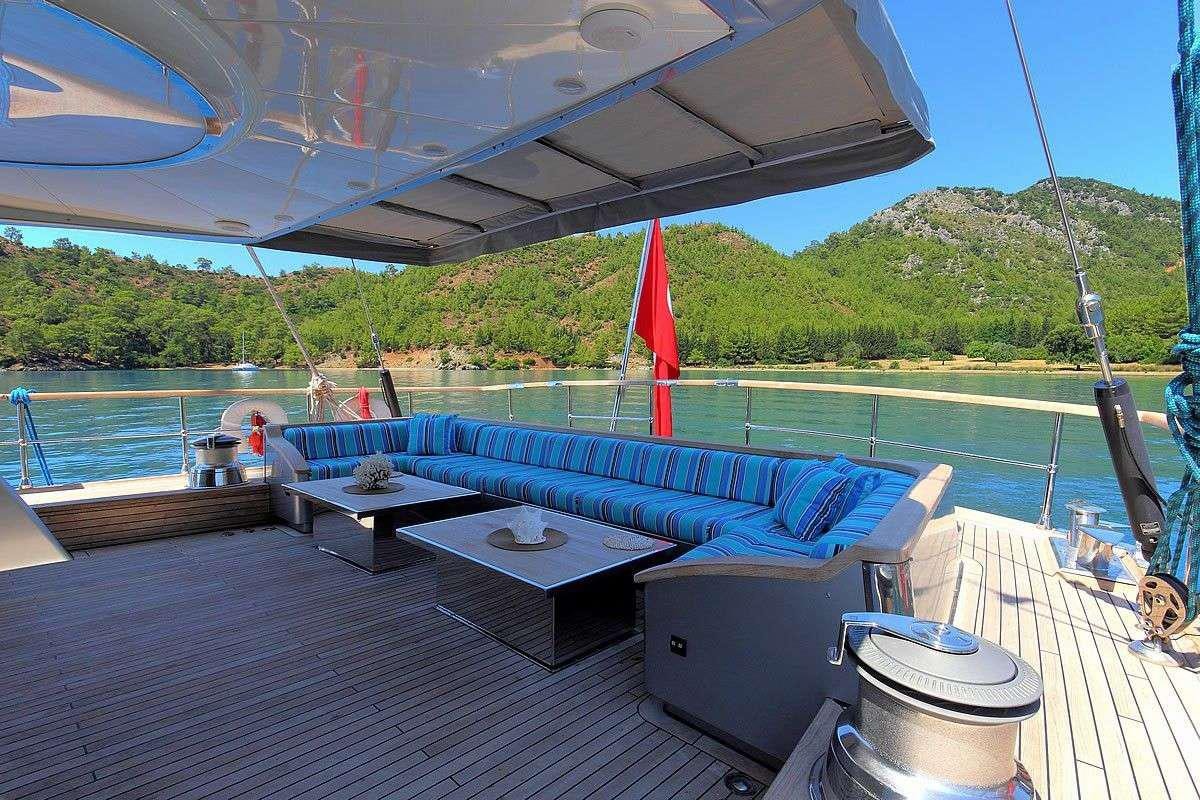 a large pool with a deck and a deck with a large sailboat aboard GO Yacht for Charter