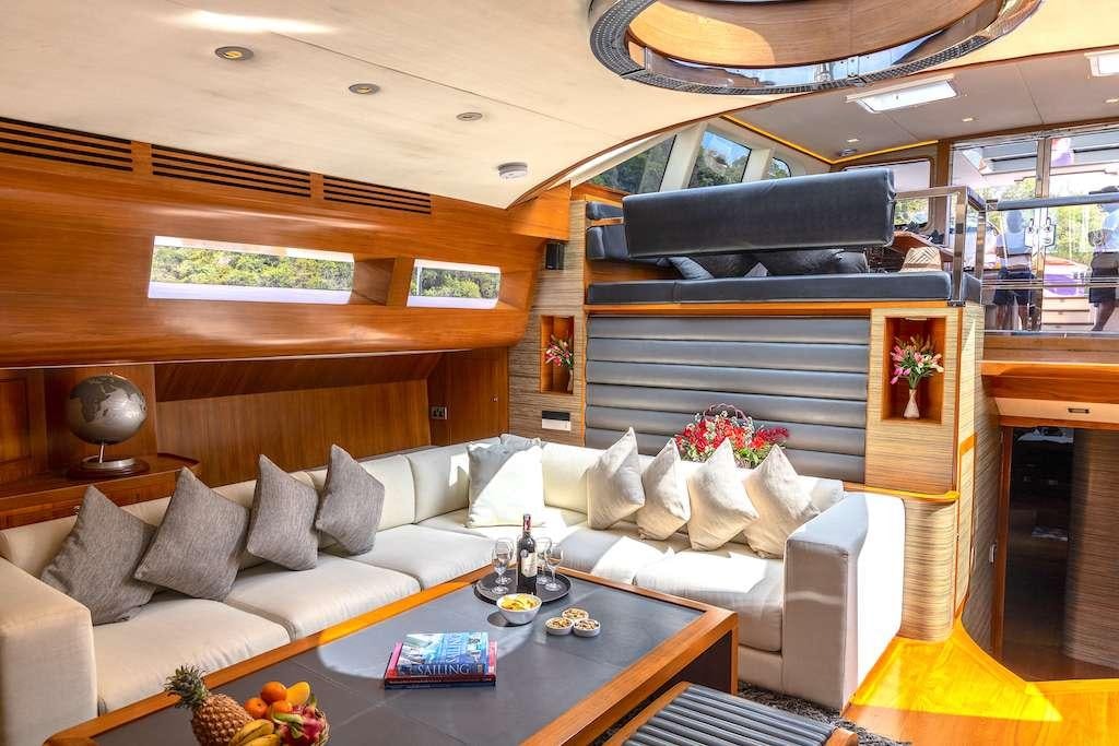a living room with a large sofa aboard SILVERLINING Yacht for Charter