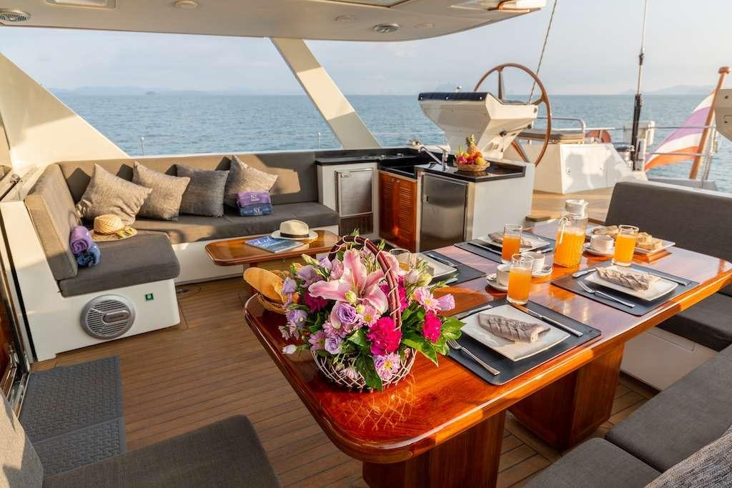 a table with a vase of flowers on it aboard SILVERLINING Yacht for Charter