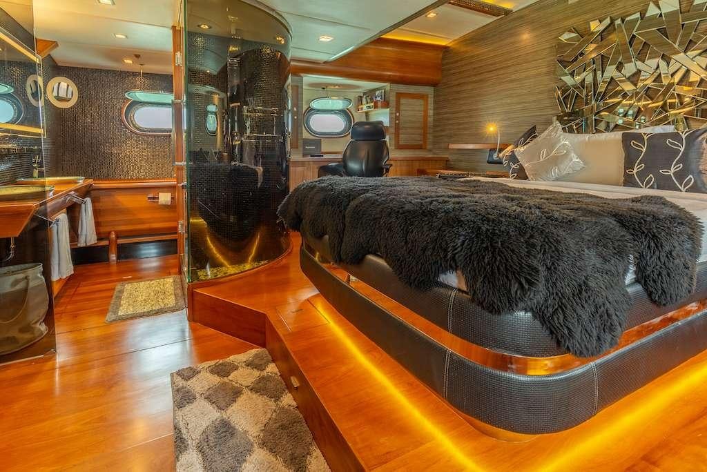 a large black dog lying on a couch in a room with wood floors aboard SILVERLINING Yacht for Charter