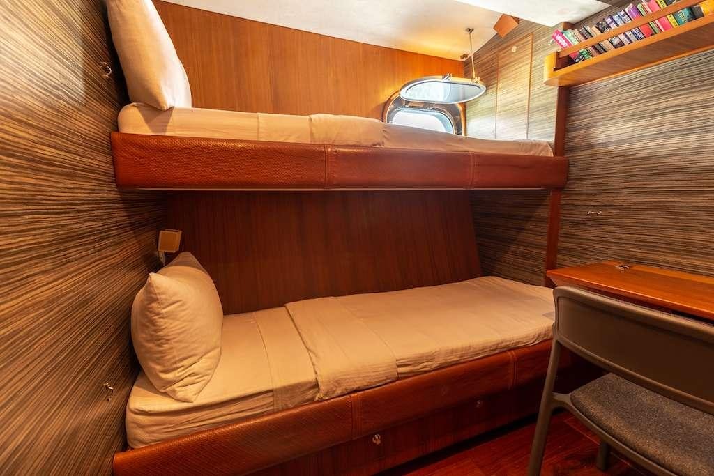 a bed with a wooden frame aboard SILVERLINING Yacht for Charter