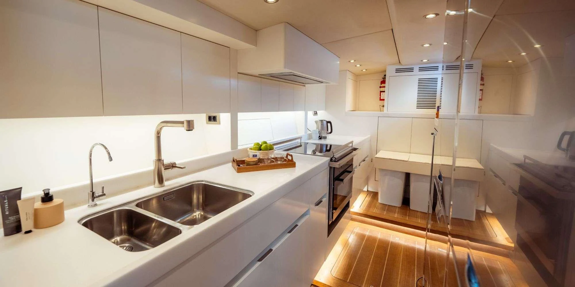 a kitchen with white cabinets aboard IKIGAI Yacht for Charter