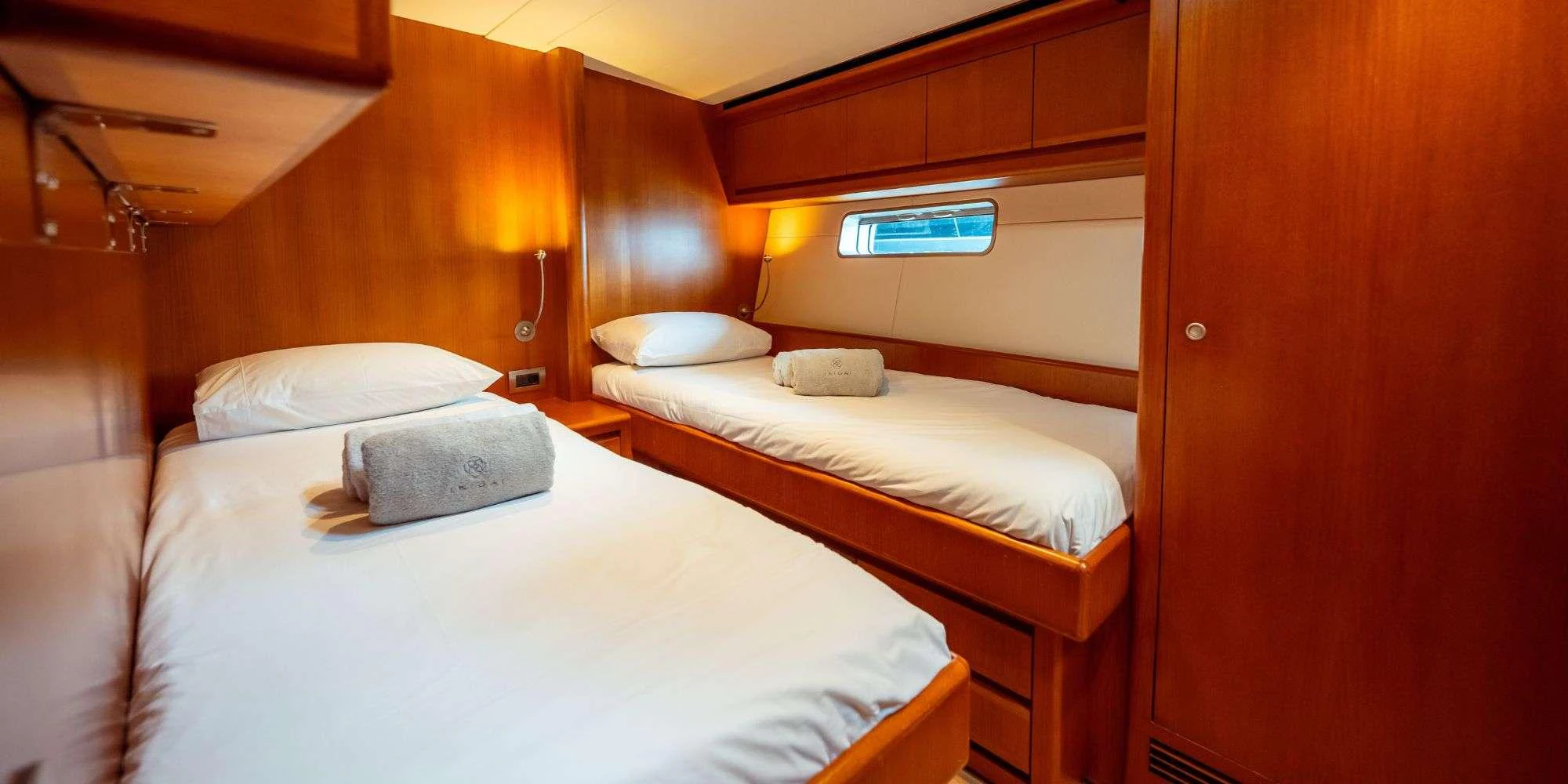 a room with two beds aboard IKIGAI Yacht for Charter