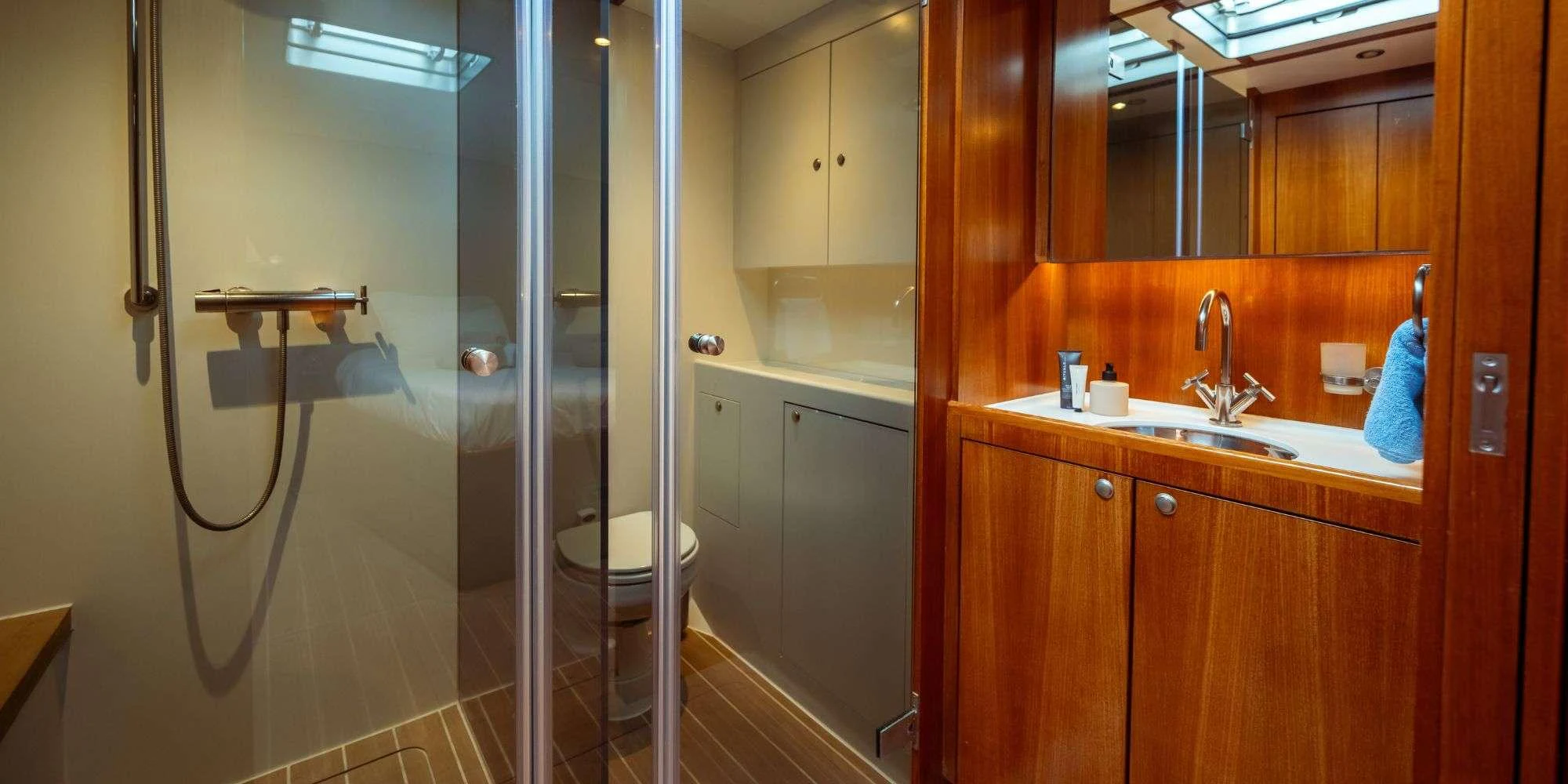 a bathroom with a glass shower aboard IKIGAI Yacht for Charter