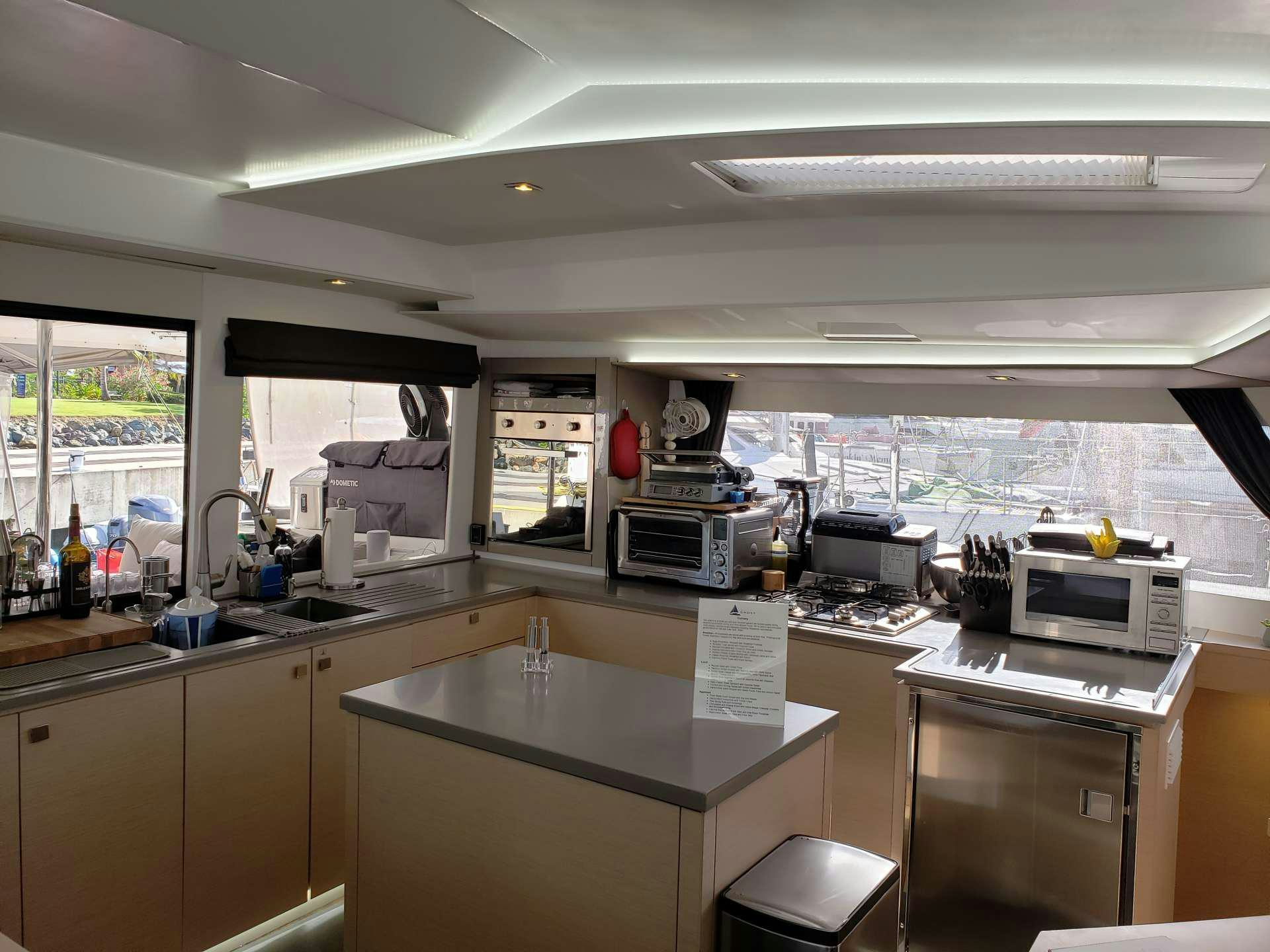 a kitchen with a lot of counter tops and appliances aboard Ghost Yacht for Charter