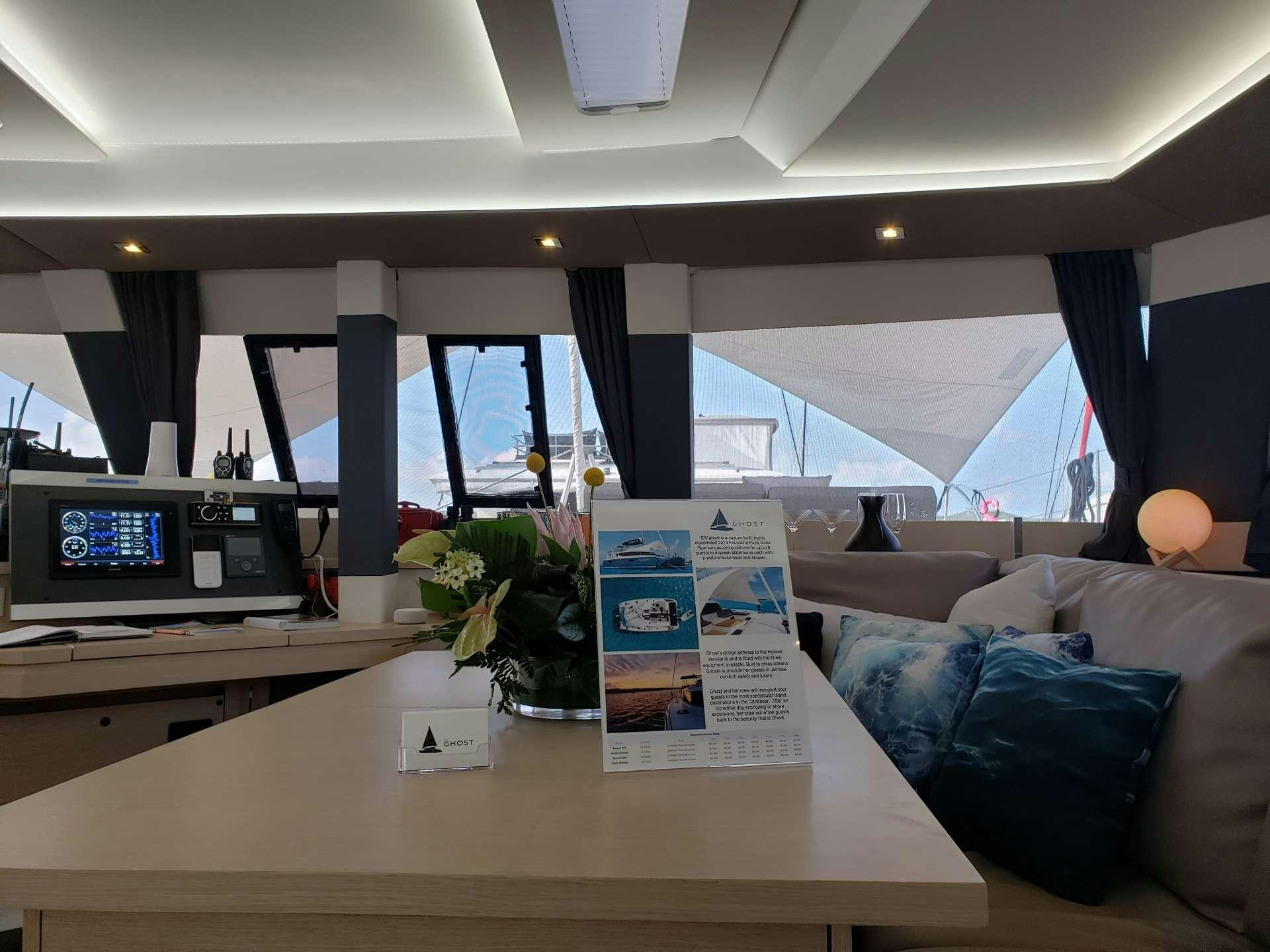 a room with a couch and a television aboard Ghost Yacht for Charter