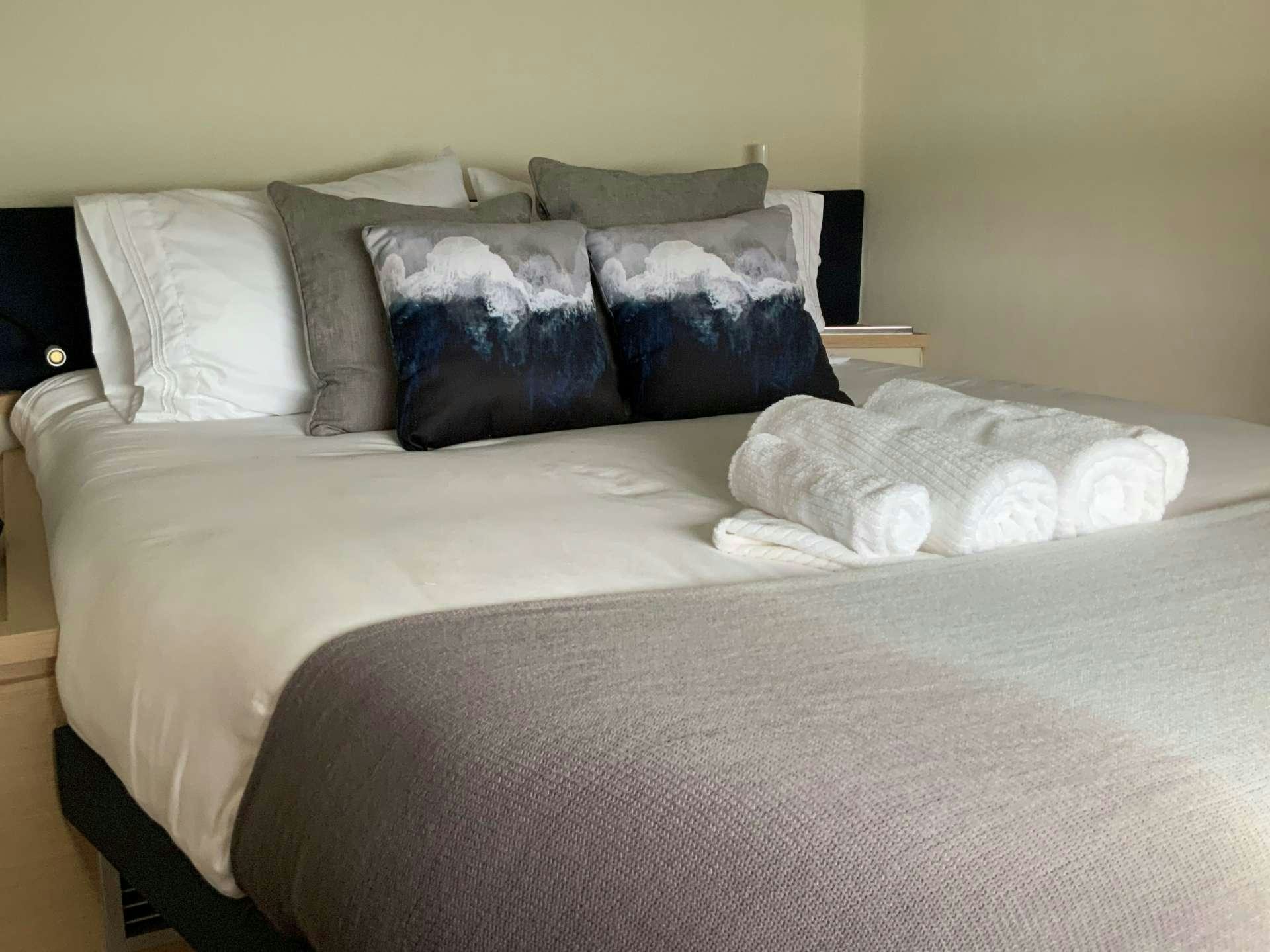 a bed with pillows aboard Ghost Yacht for Charter