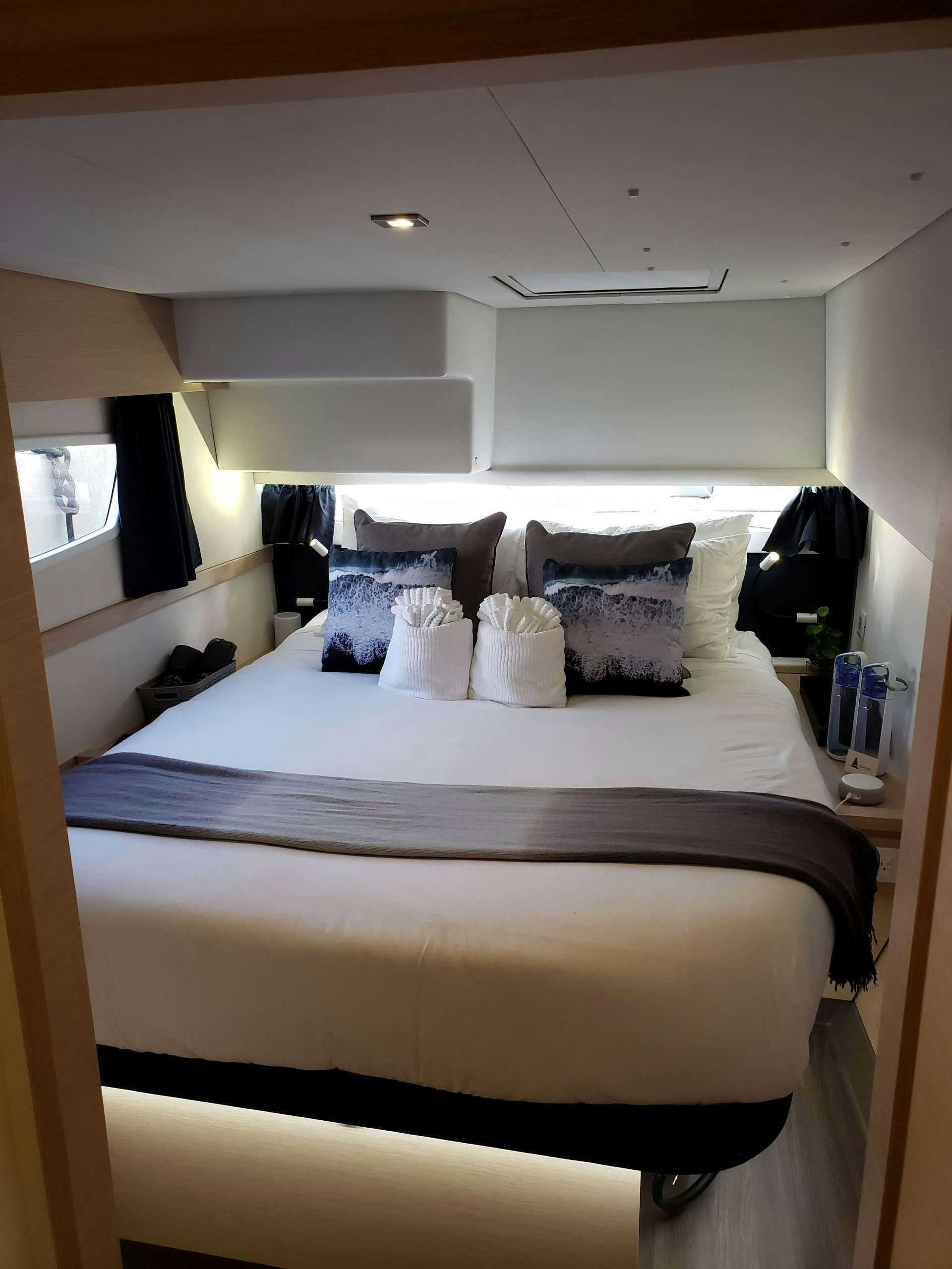 a couple of beds in a hotel room aboard Ghost Yacht for Charter
