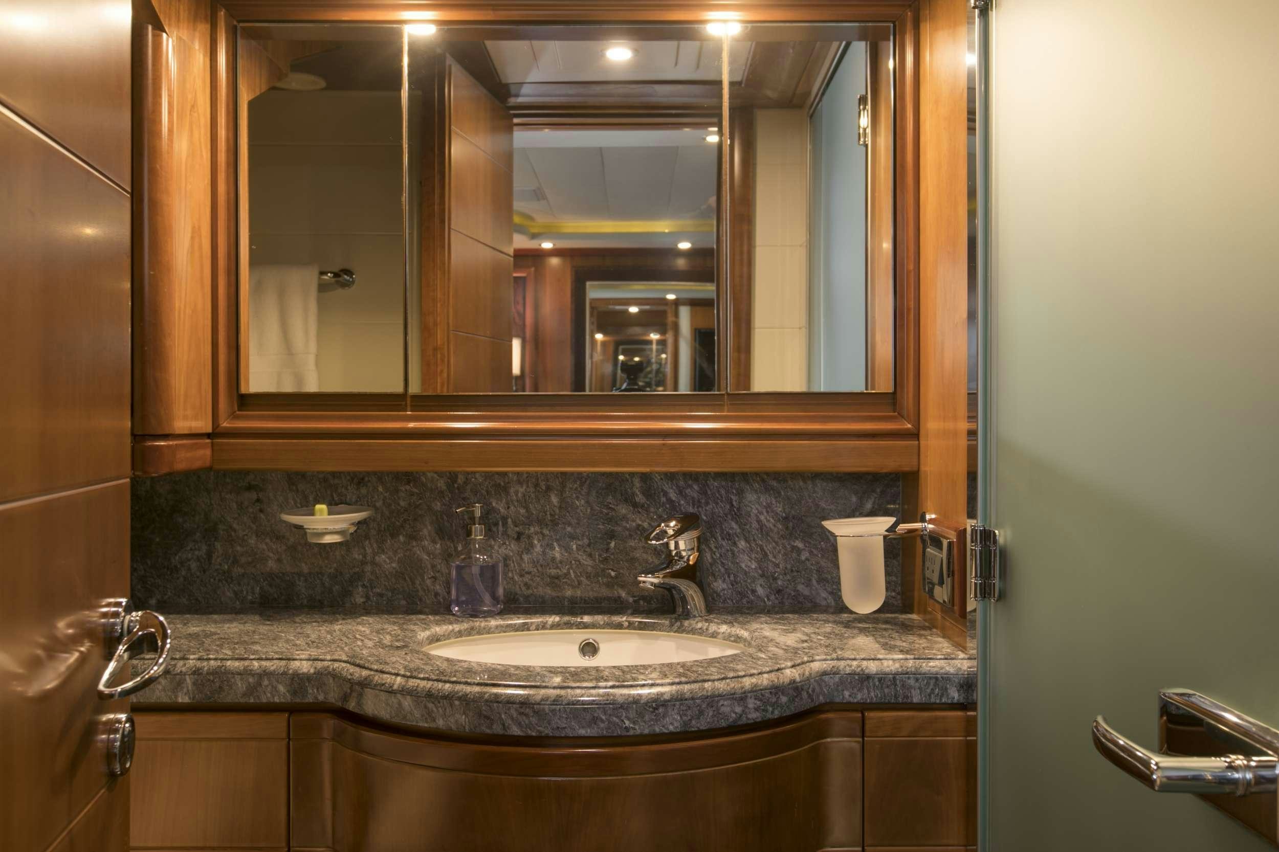 a bathroom with a large mirror aboard MAMBO Yacht for Charter