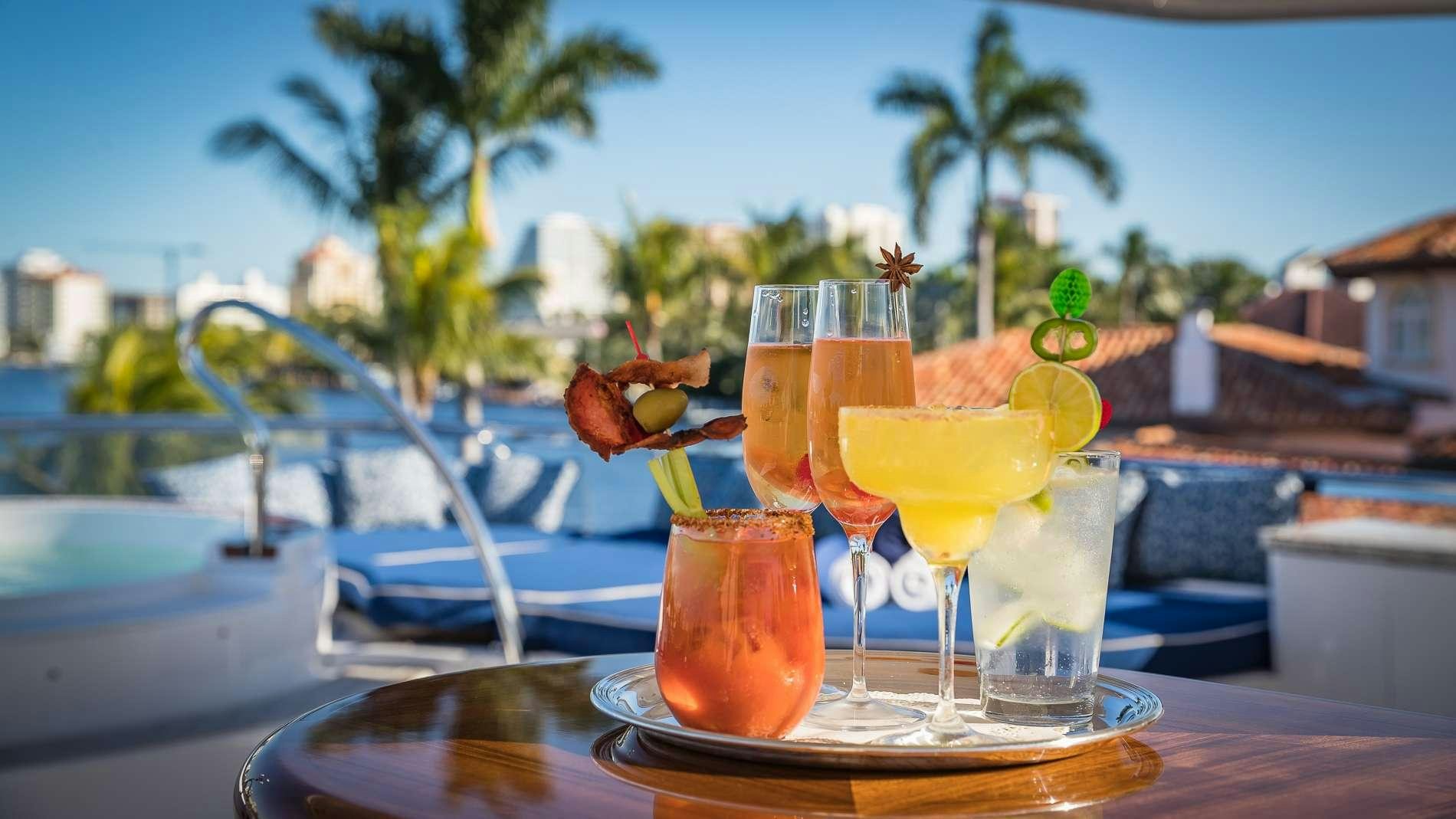 a group of glasses with drinks on a table aboard MAMBO Yacht for Charter