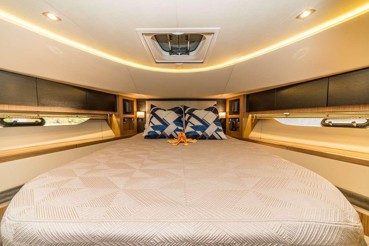 a room with a bed and a desk aboard KRAKEN Yacht for Charter
