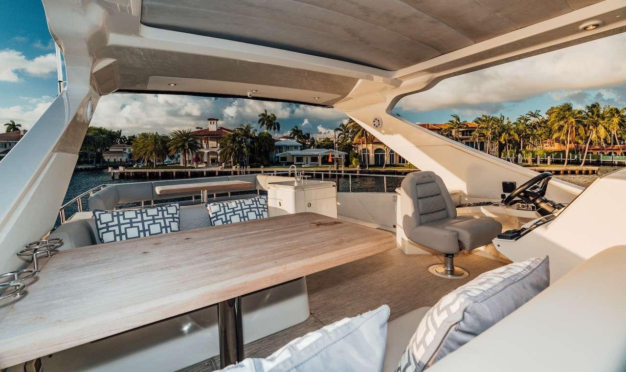 a room with a couch and a table and chairs aboard KRAKEN Yacht for Charter