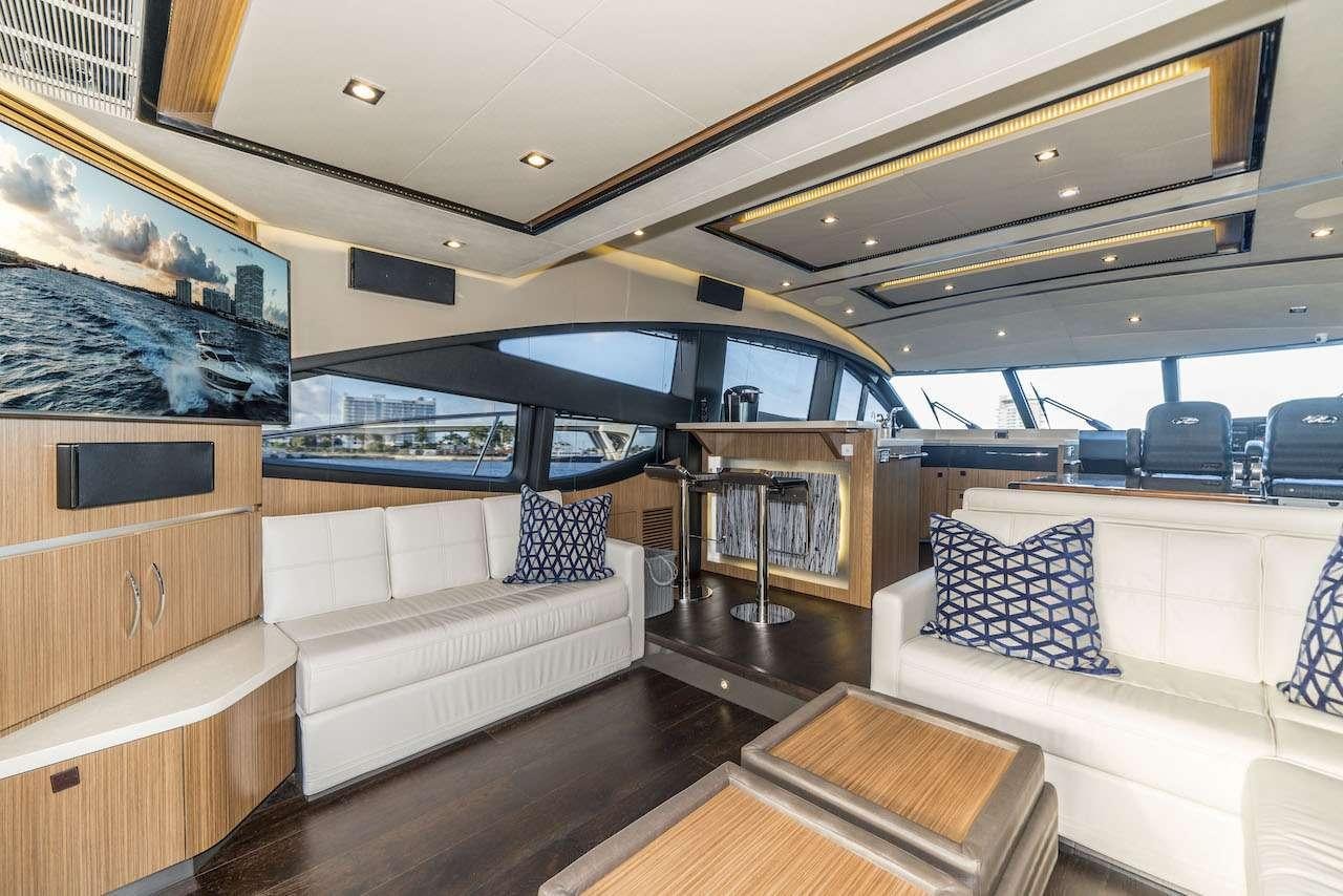 a living room with a couch and a television aboard KRAKEN Yacht for Charter