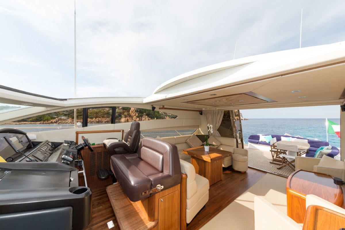 a boat with a lounge chair and a table and chairs on a deck aboard ASPIRE OF LONDON Yacht for Charter