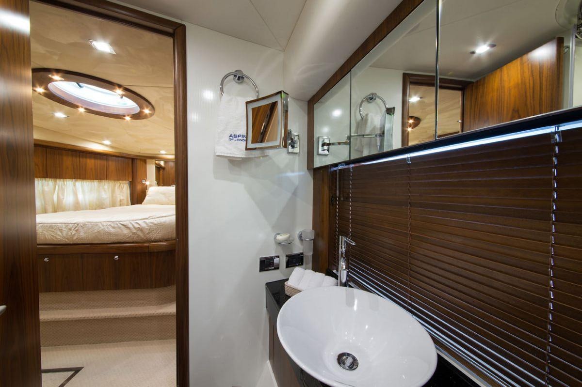 a bathroom with a sink and a bed aboard ASPIRE OF LONDON Yacht for Charter