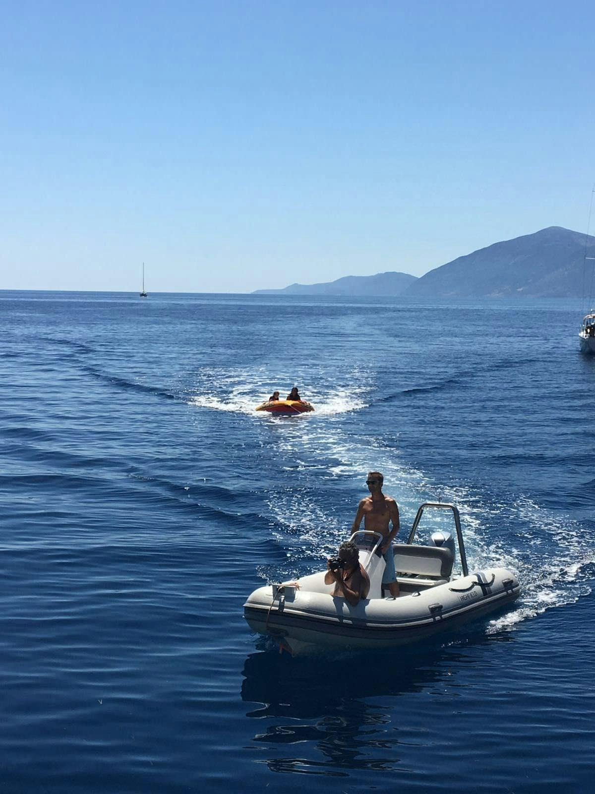 a man and a dog on a boat in the water aboard BIG GANI Yacht for Charter