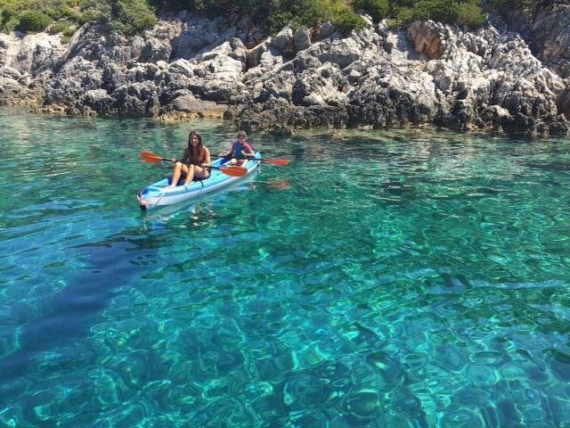 a couple of people in a canoe in the water aboard BIG GANI Yacht for Charter