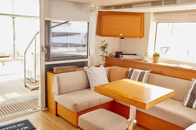 a living room with a table and couches aboard BIG GANI Yacht for Charter
