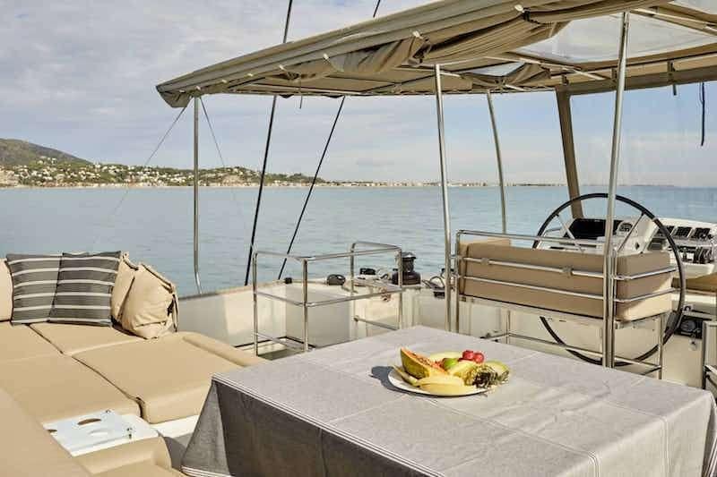 a table with a plate of food on it aboard BIG GANI Yacht for Charter