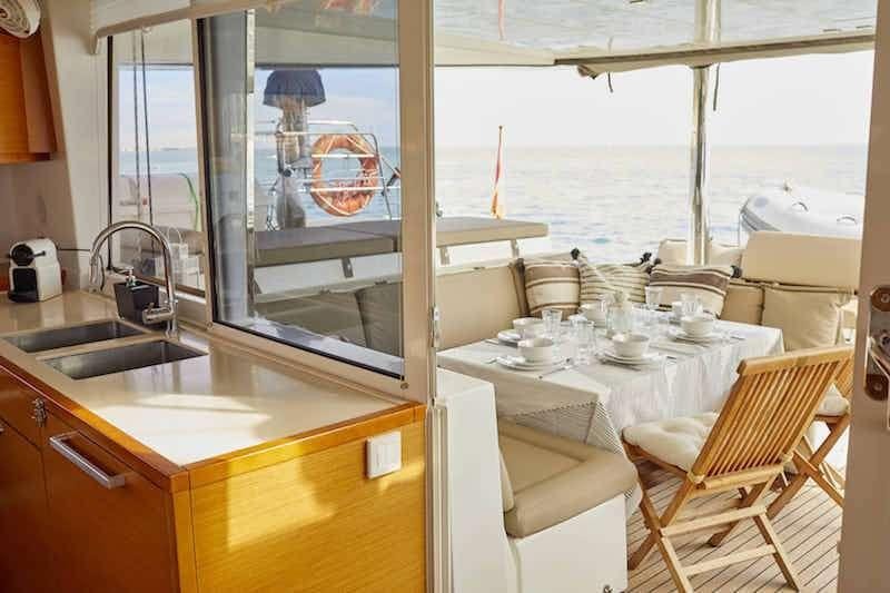 a kitchen with a sink and a table aboard BIG GANI Yacht for Charter