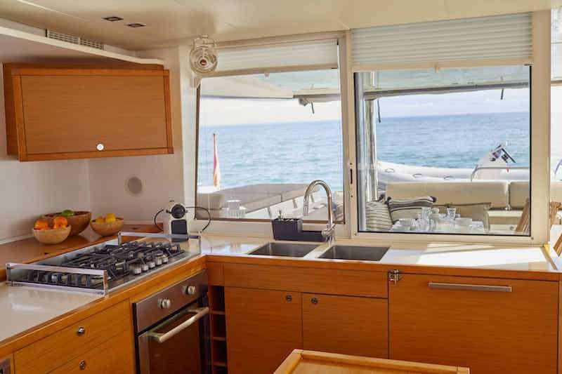 a kitchen with a sink and a window aboard BIG GANI Yacht for Charter