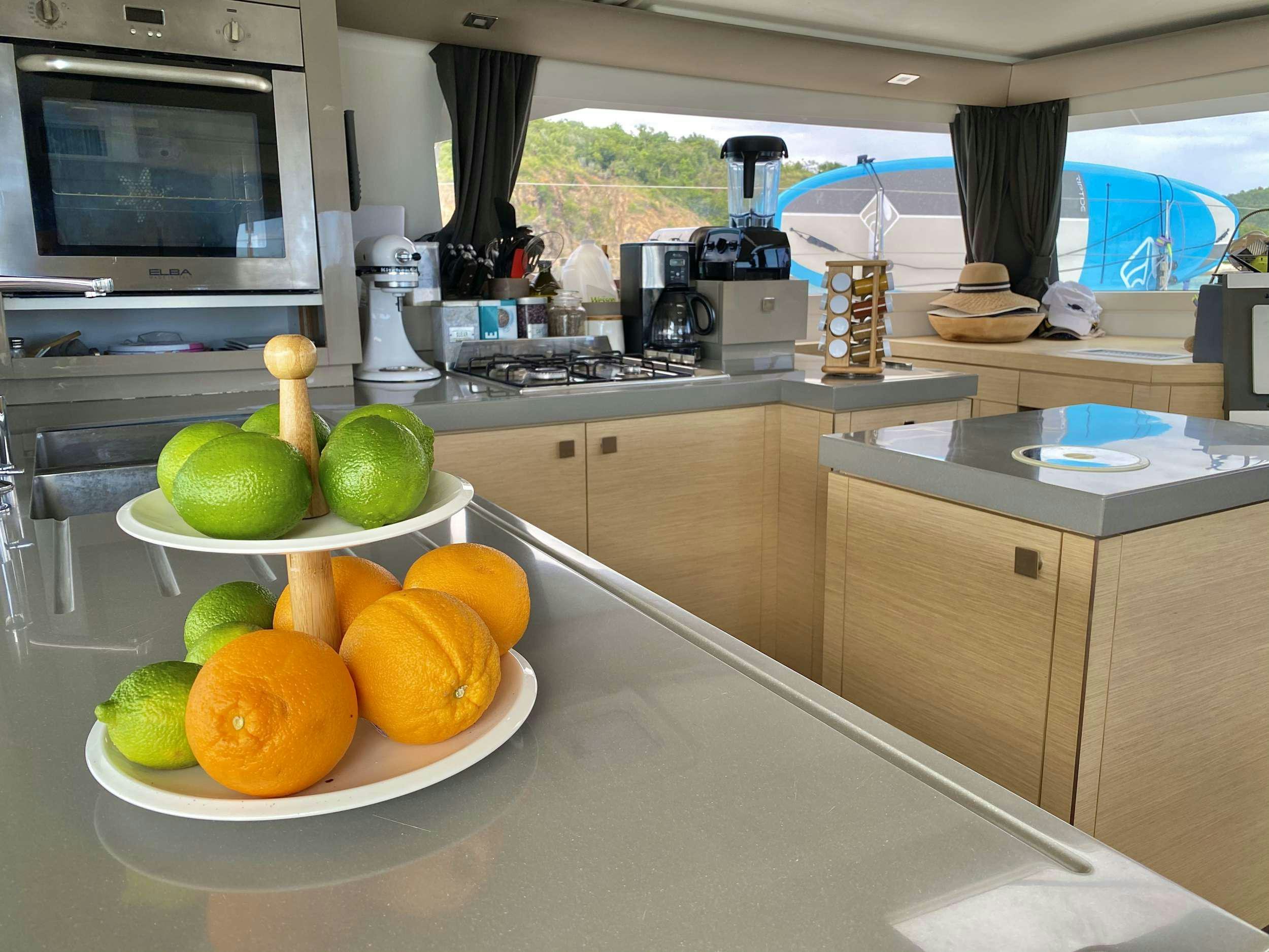 a kitchen counter with fruit aboard BLACK TORTUGA Yacht for Charter