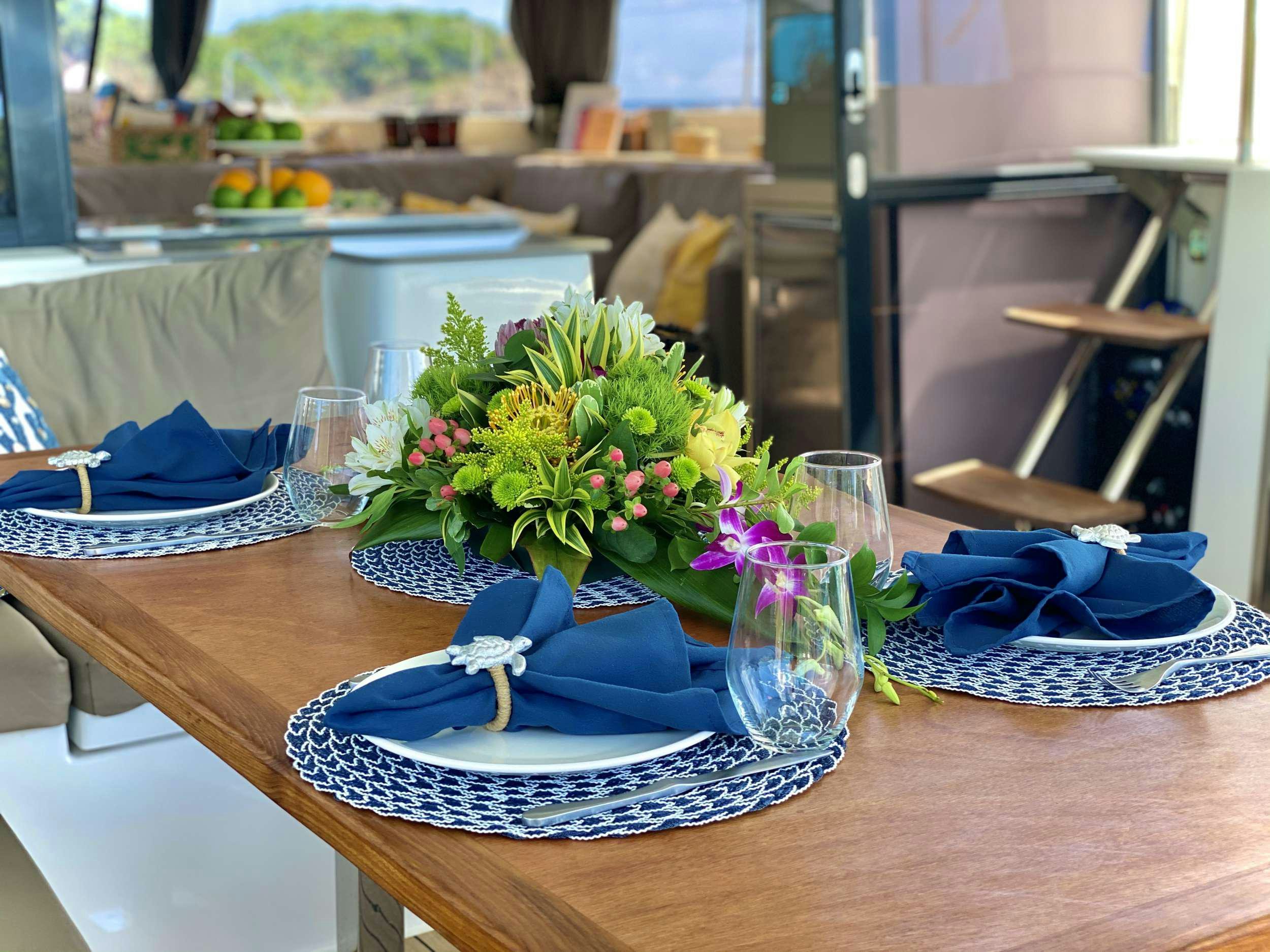 a table with a vase of flowers aboard BLACK TORTUGA Yacht for Charter